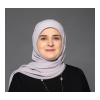 Zainab wearing a purple scarf, and a necklace