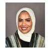 Headshot image of Dr. Mariam Alkheder, a pediatric dentist and assistant professor, wearing formal attire against a neutral background